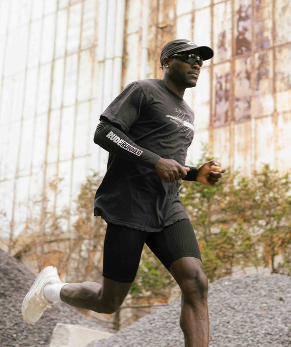 Man running outdoors with a building in the background